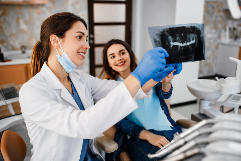 Dentist reviewing a dental X-ray with a patient at Creekside Family Dental